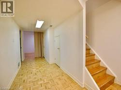 Hallway with stairs and baseboards -
