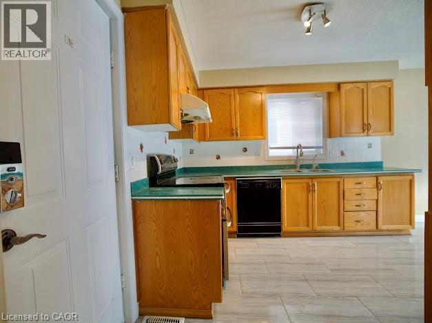 Kitchen with dishwasher, stainless steel range with electric cooktop, under cabinet range hood, and tasteful backsplash - 109 Beechmanor Crescent, Kitchener, ON - Indoor Photo Showing Kitchen