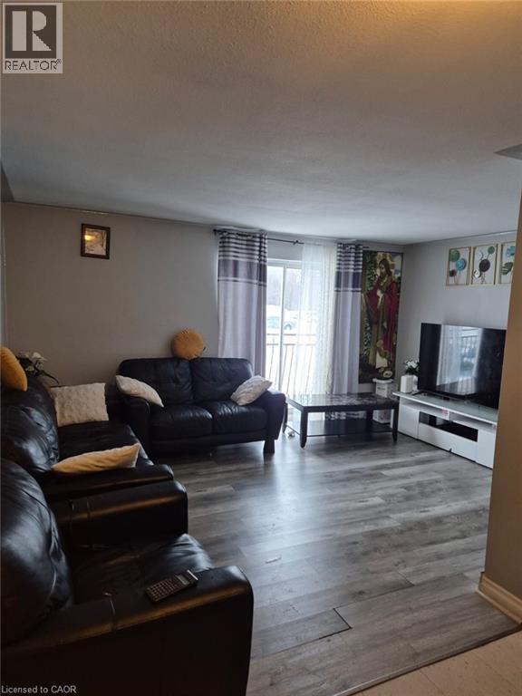 Living room featuring wood finished floors - 76 Brybeck Crescent Unit# 204, Kitchener, ON - Indoor Photo Showing Living Room