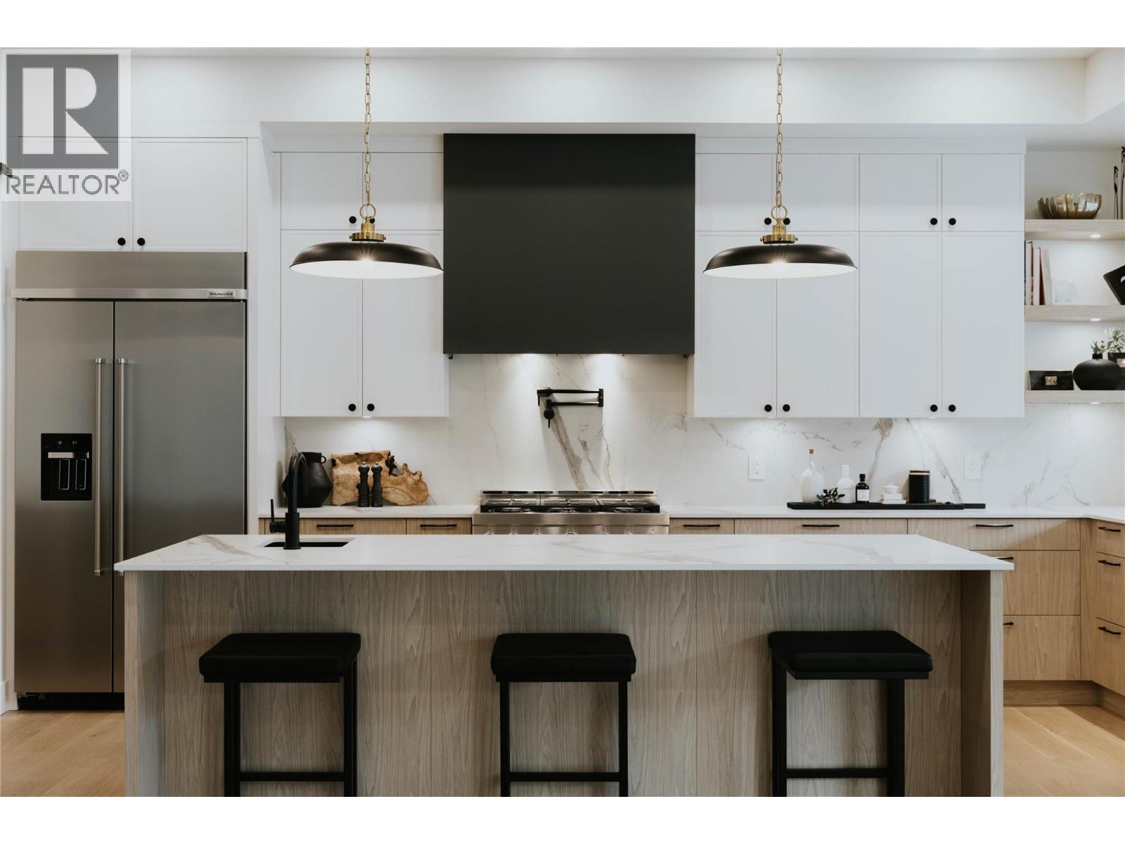 Exquisitely designed kitchen featuring Dekton countertops and backsplash, renowned for their durability. - 5533 Foothill Court, Kelowna, BC - Indoor Photo Showing Kitchen With Upgraded Kitchen