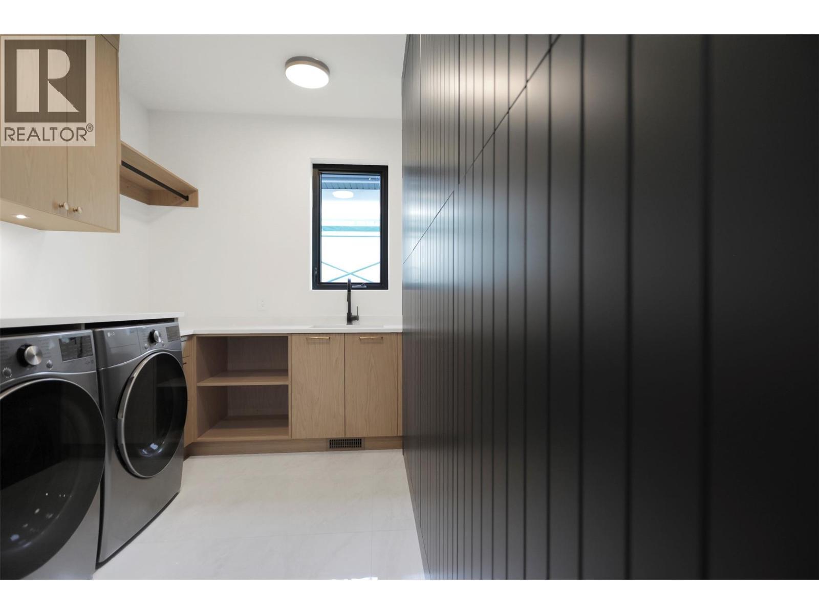 Well-designed laundry room with a functional layout and ample storage space - 5533 Foothill Court, Kelowna, BC - Indoor Photo Showing Laundry Room