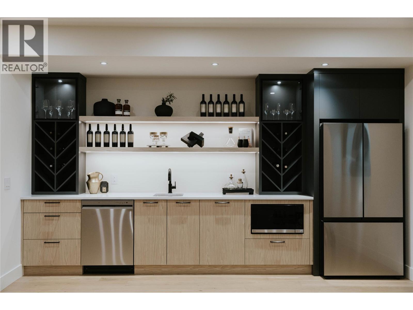 A fully equipped basement rec room featuring a dishwasher, microwave, and fridge - 5533 Foothill Court, Kelowna, BC - Indoor Photo Showing Kitchen