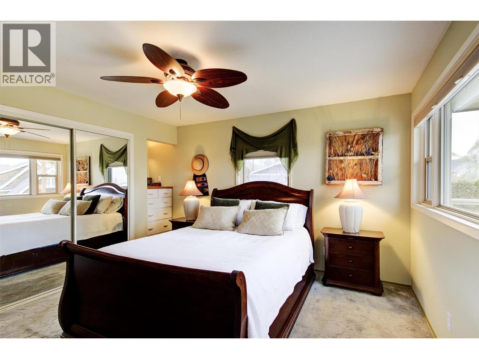 Primary bedroom with closet with access to the patio - 391 Braeloch Road, Kelowna, BC - Indoor Photo Showing Bedroom
