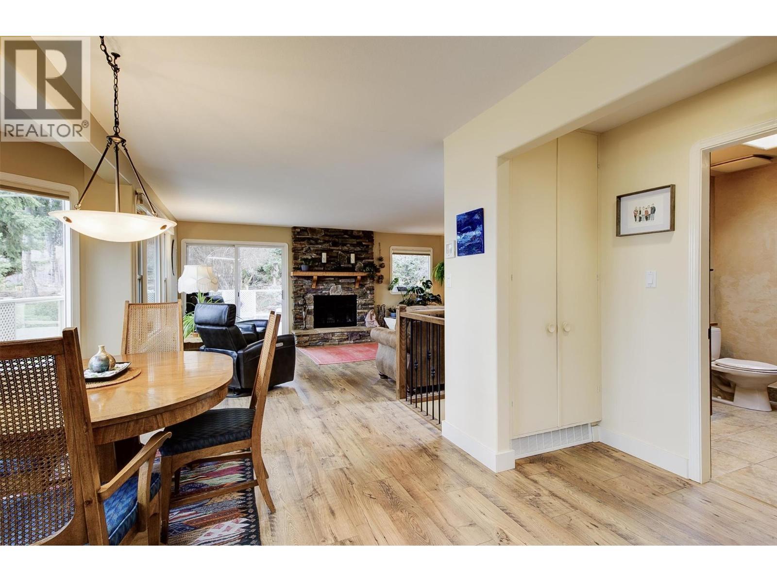 Flooring in Kitchen, dining, and living room replaced in 2018 - 391 Braeloch Road, Kelowna, BC - Indoor With Fireplace