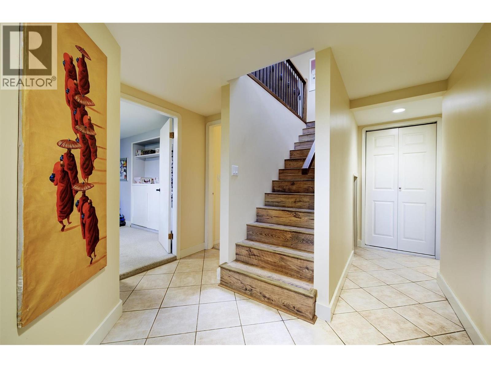 Lower level foyer. Stairs to main level renovated in 2018 - 391 Braeloch Road, Kelowna, BC - Indoor Photo Showing Other Room