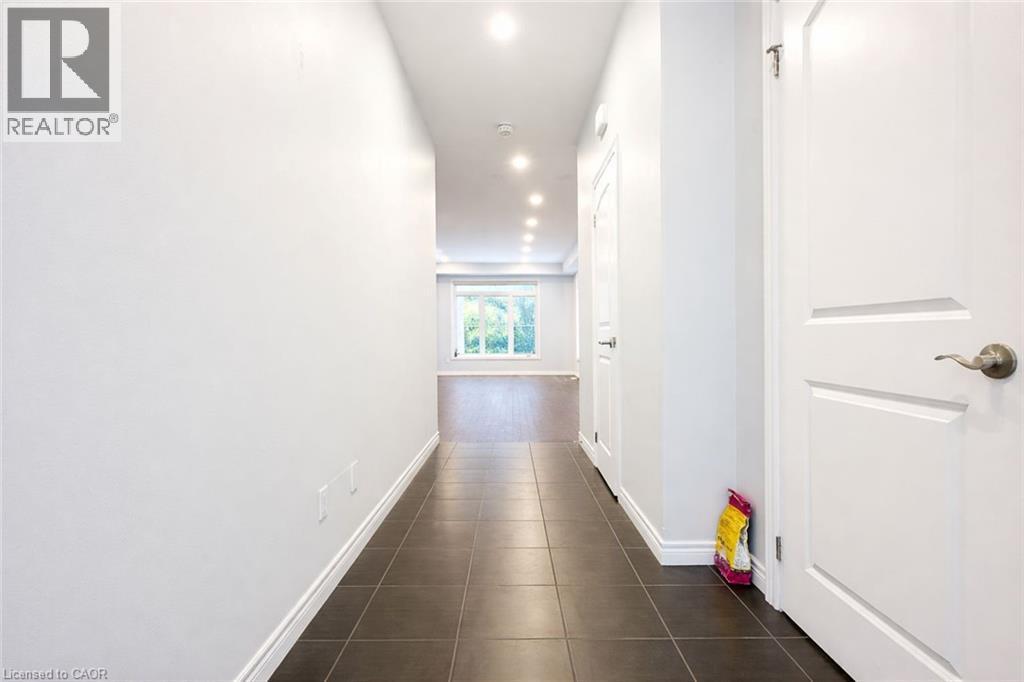 Hallway featuring recessed lighting and dark tile patterned flooring - 127 Elmbank Trail Unit# Upper, Kitchener, ON - Indoor Photo Showing Other Room