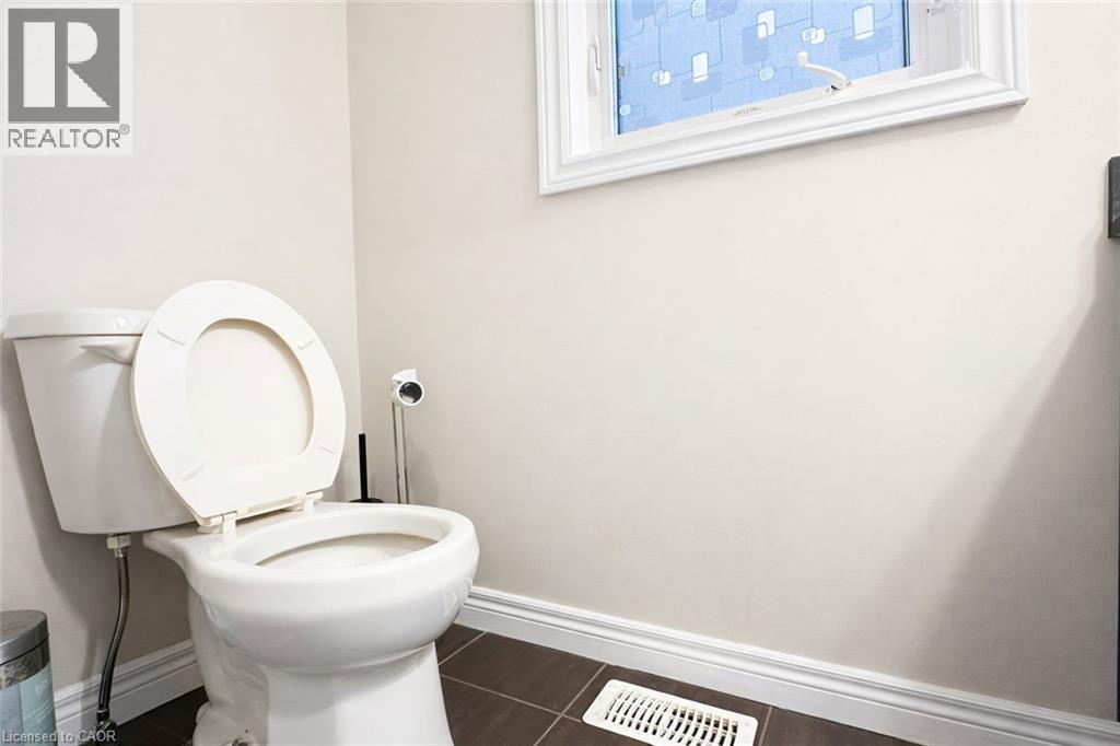 Bathroom featuring dark tile patterned flooring and baseboards - 127 Elmbank Trail Unit# Upper, Kitchener, ON - Indoor Photo Showing Bathroom