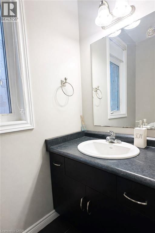 Bathroom with vanity and dark tile patterned flooring - 127 Elmbank Trail Unit# Upper, Kitchener, ON - Indoor Photo Showing Bathroom