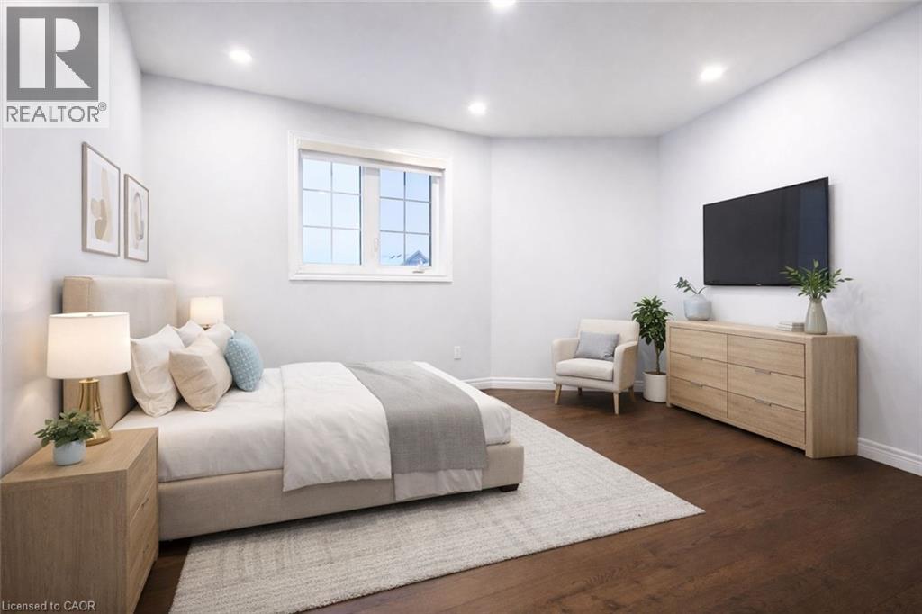 Bedroom with dark wood finished floors and recessed lighting - 127 Elmbank Trail Unit# Upper, Kitchener, ON - Indoor Photo Showing Bedroom