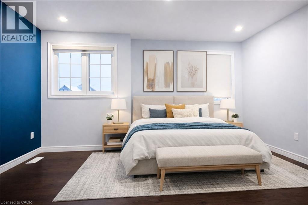 Bedroom with dark wood finished floors and recessed lighting - 127 Elmbank Trail Unit# Upper, Kitchener, ON - Indoor Photo Showing Bedroom