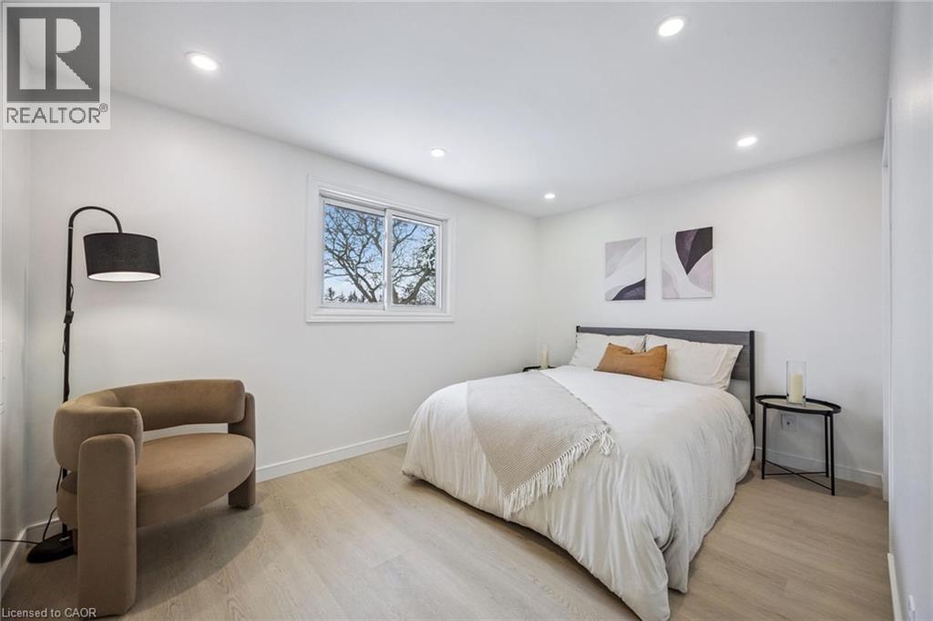 Bedroom with light wood finished floors and recessed lighting - 21 Forest Glen Court, Kitchener, ON - Indoor Photo Showing Bedroom