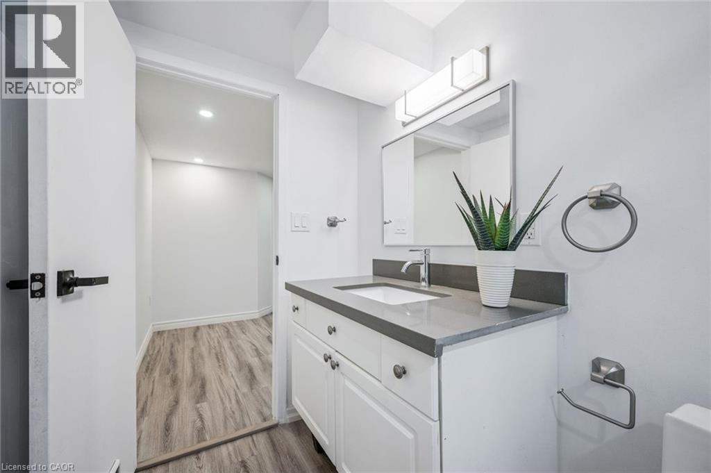Bathroom featuring vanity, light wood-type flooring, and recessed lighting - 21 Forest Glen Court, Kitchener, ON - Indoor Photo Showing Bathroom
