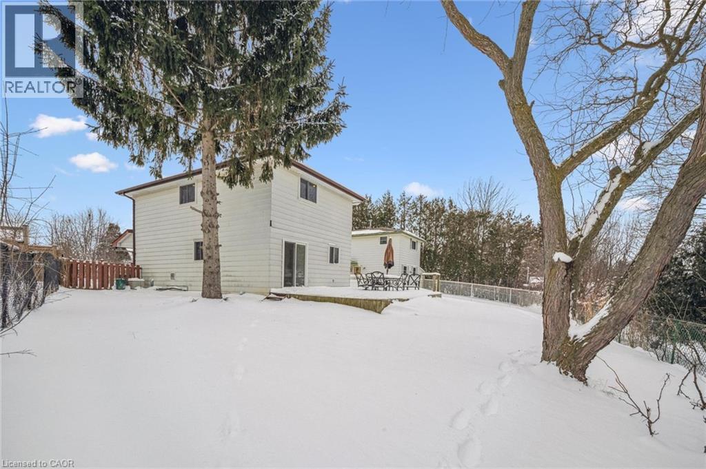 Snow covered rear of property featuring a wooden deck - 21 Forest Glen Court, Kitchener, ON - Outdoor