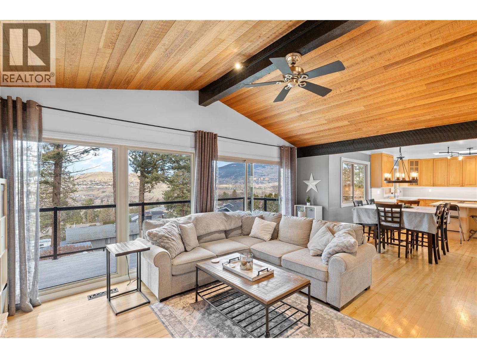 Patio doors leading to top deck - 11609 Upper Summit Drive, Coldstream, BC - Indoor Photo Showing Living Room