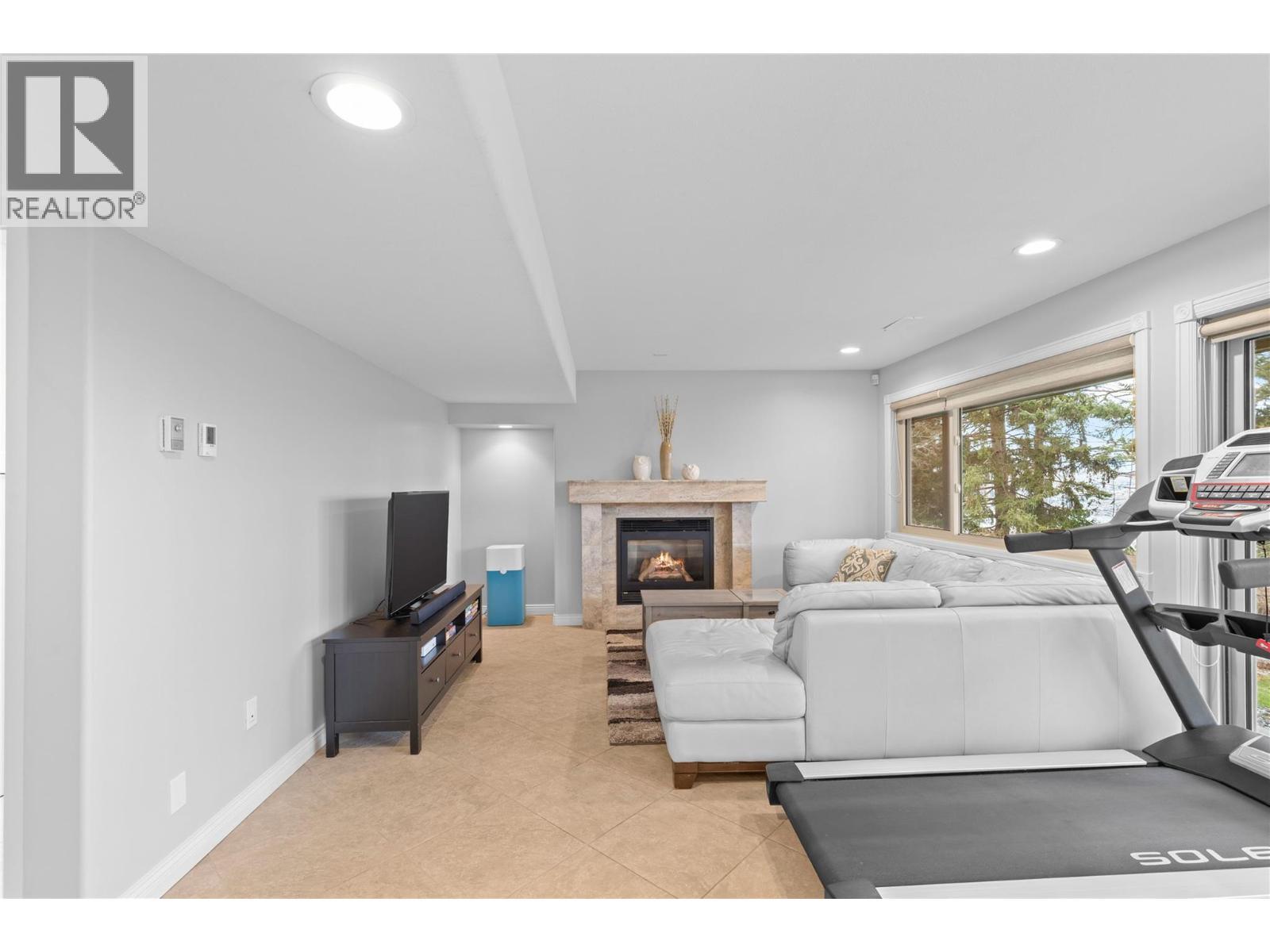 Rec room in basement - 11609 Upper Summit Drive, Coldstream, BC - Indoor With Fireplace