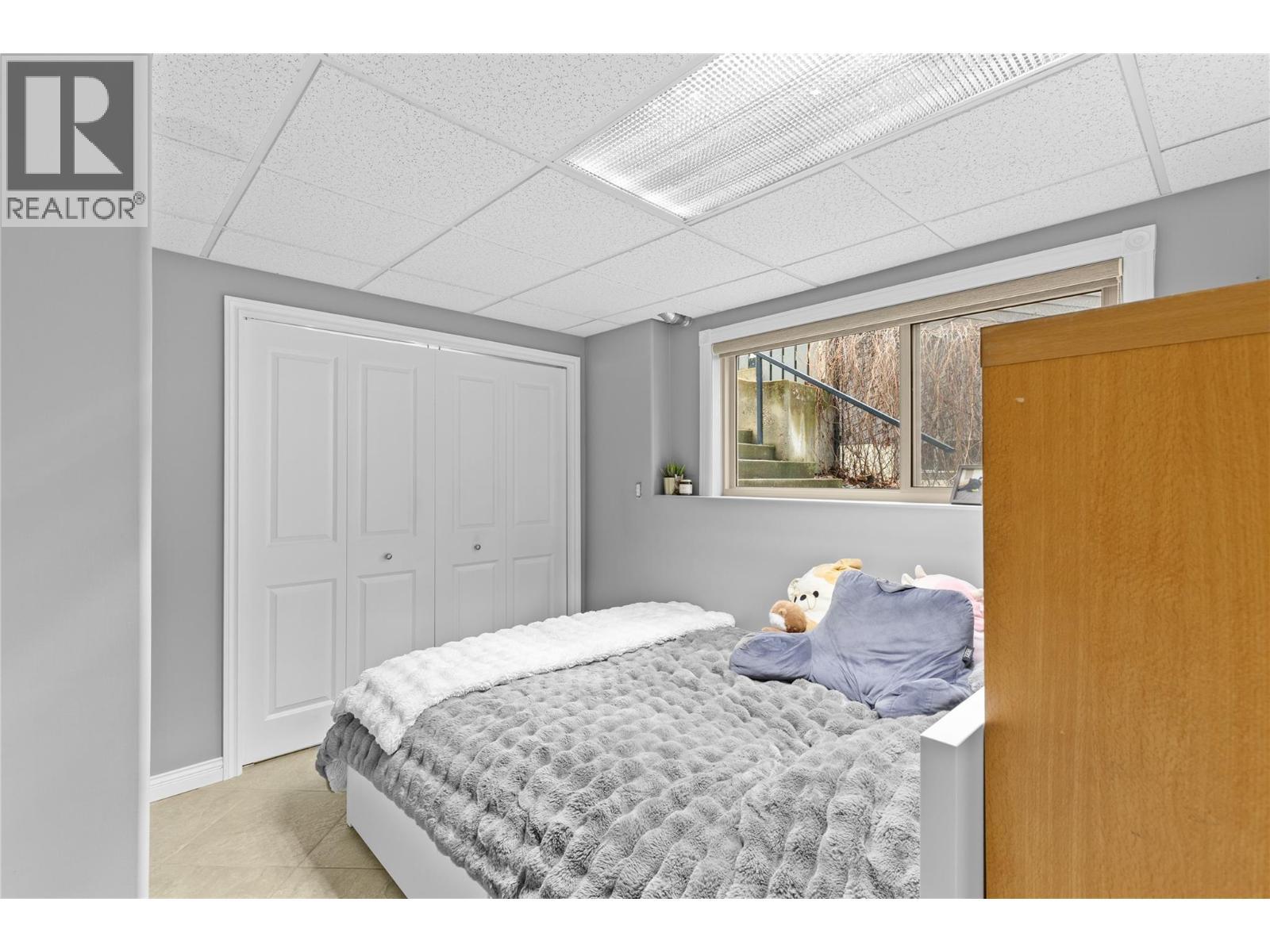 Bedroom in basement belongs to main home - 11609 Upper Summit Drive, Coldstream, BC - Indoor Photo Showing Bedroom