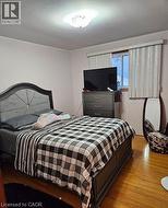 Bedroom featuring wood finished floors -