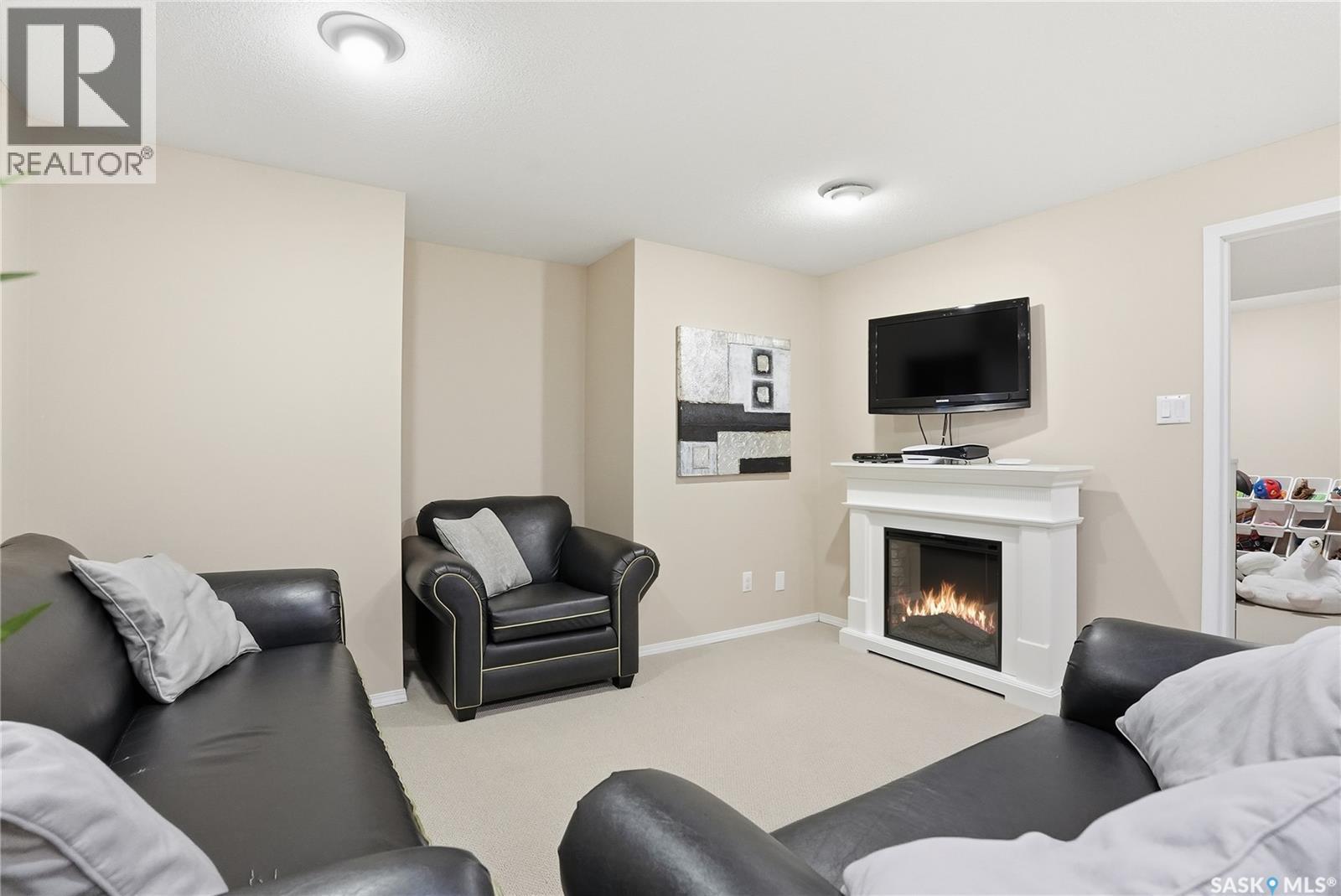 215 Wickenden Crescent, Saskatoon, SK - Indoor Photo Showing Living Room With Fireplace
