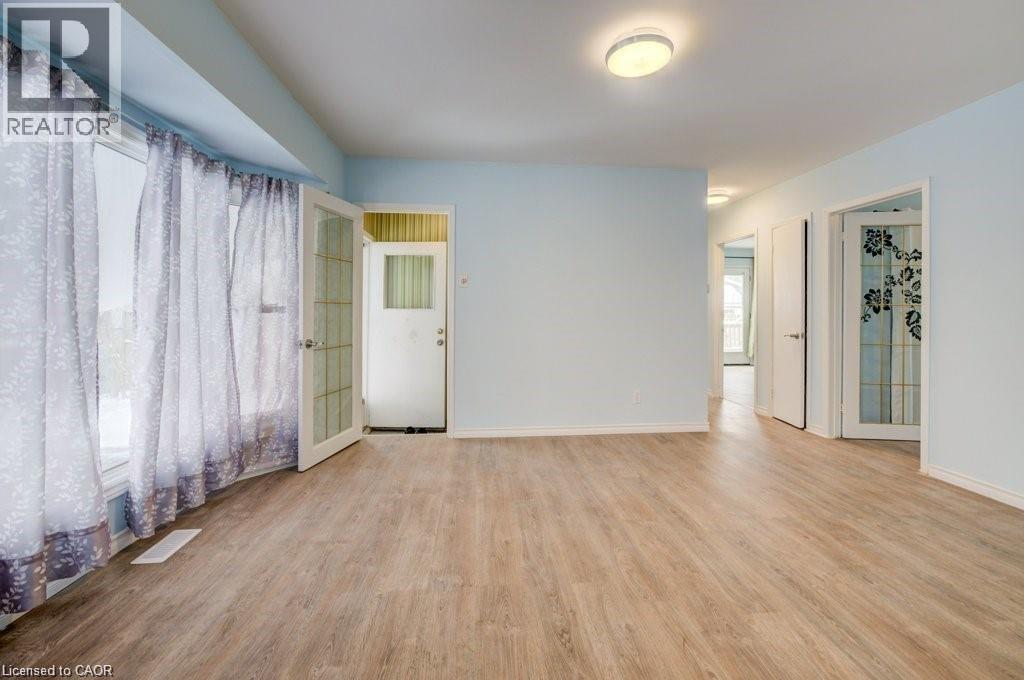 Empty room with plenty of natural light and light wood-style flooring - 33 Garland Crescent, London, ON - Indoor Photo Showing Other Room