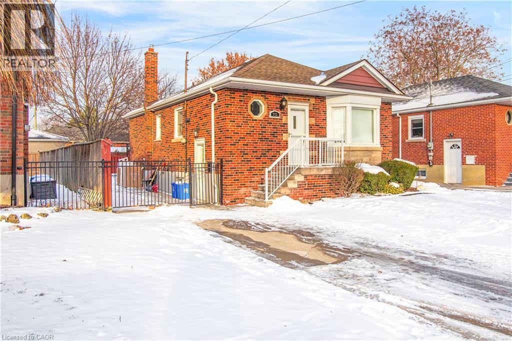 View of front of property featuring a chimney and brick siding - 773 Queensdale Avenue E, Hamilton, ON - Outdoor
