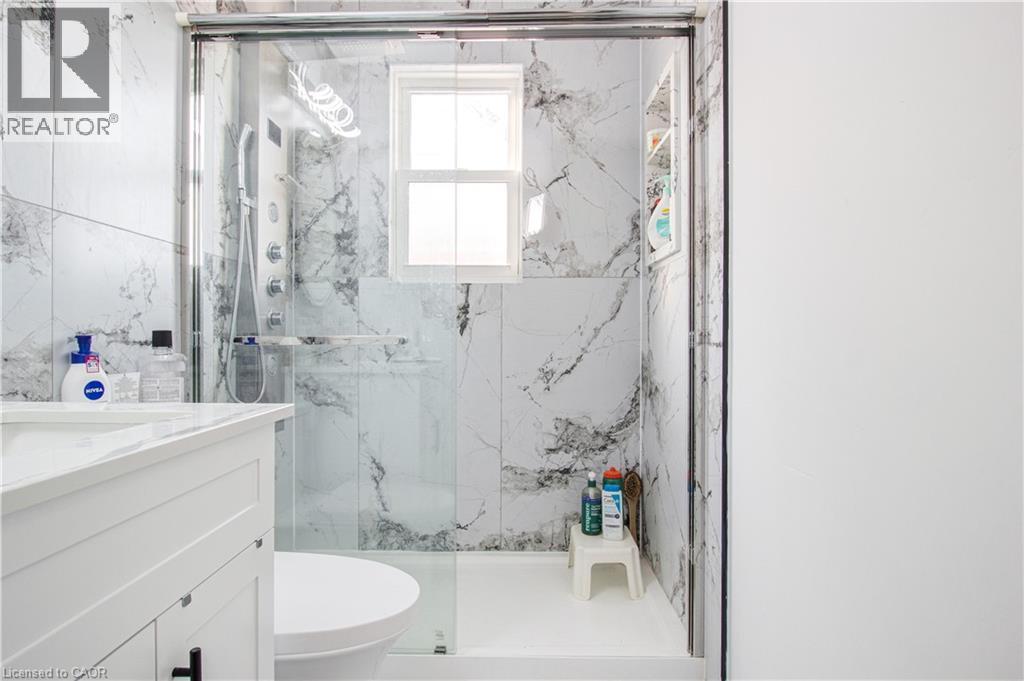 Full bath featuring vanity and a marble finish shower - 773 Queensdale Avenue E, Hamilton, ON - Indoor Photo Showing Bathroom