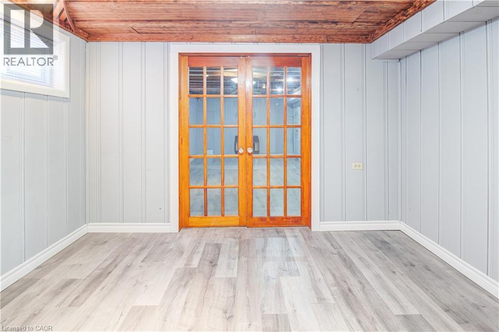 Unfurnished room featuring wood ceiling, light wood-style flooring, and french doors - 773 Queensdale Avenue E, Hamilton, ON - Indoor Photo Showing Other Room
