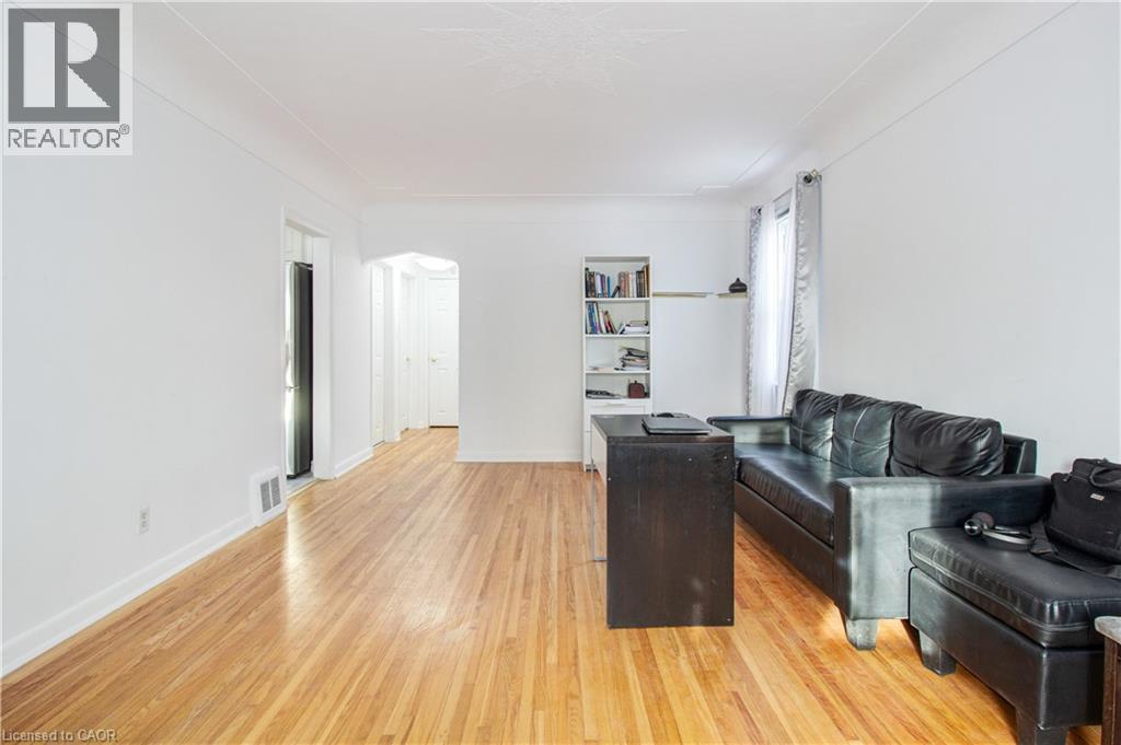 Living area with light wood-type flooring and arched walkways - 773 Queensdale Avenue E, Hamilton, ON - Indoor