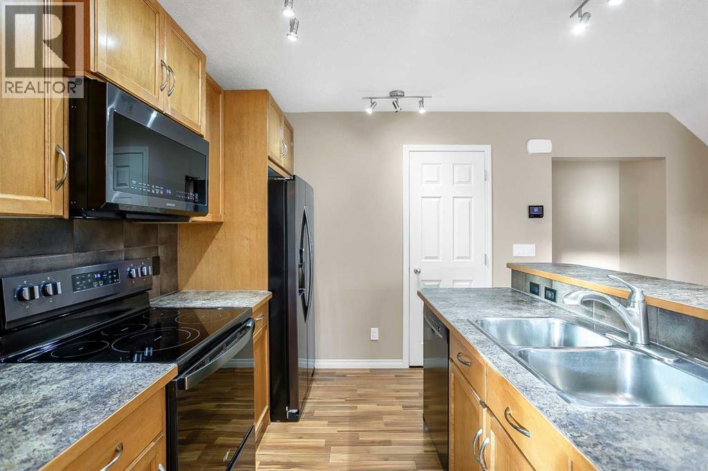 37 Silverado Saddle Avenue Sw, Calgary, AB - Indoor Photo Showing Kitchen With Double Sink