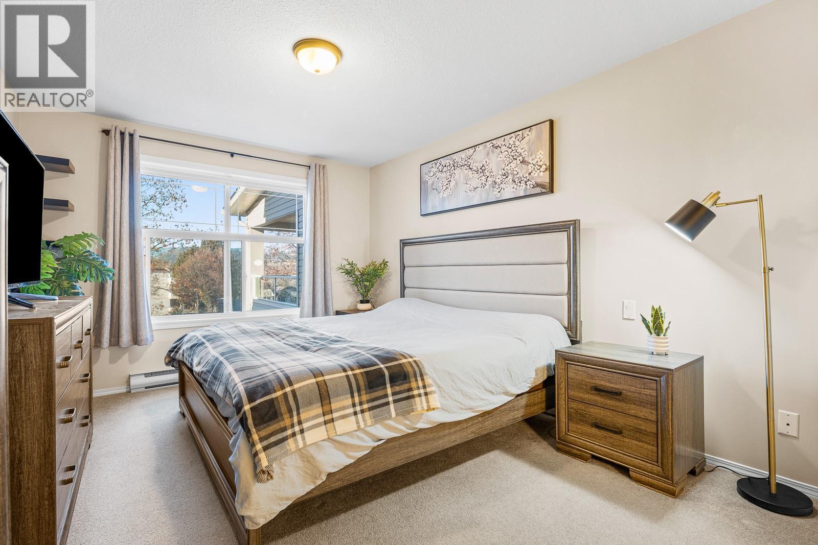 Spacious and Bright Master Bedroom - 555 Houghton Road Unit# 206, Kelowna, BC - Indoor Photo Showing Bedroom