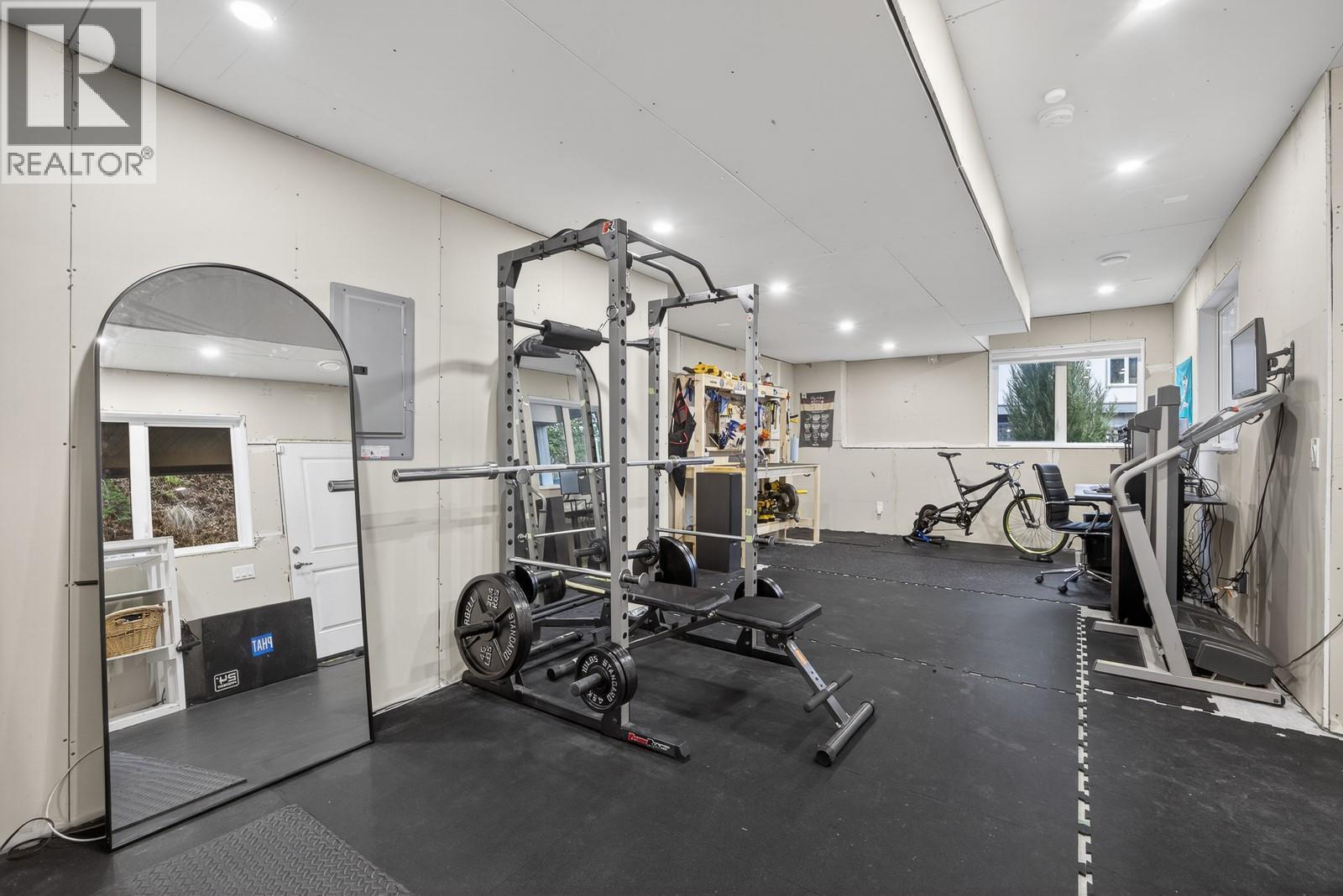 Versatile Basement Space Easily Converted Into A Bedroom, Home Office, or Rec Room - 2893 Robinson Road Unit# 5, Lake Country, BC - Indoor Photo Showing Gym Room