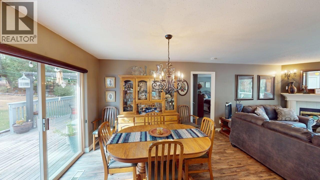 5270 Mackay Crescent, 108 Mile Ranch, BC - Indoor Photo Showing Dining Room With Fireplace