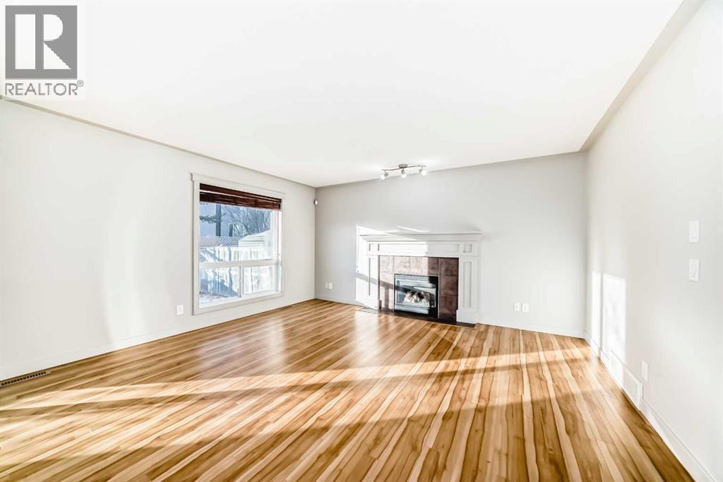 1156 Sherwood Boulevard Nw, Calgary, AB - Indoor Photo Showing Living Room With Fireplace
