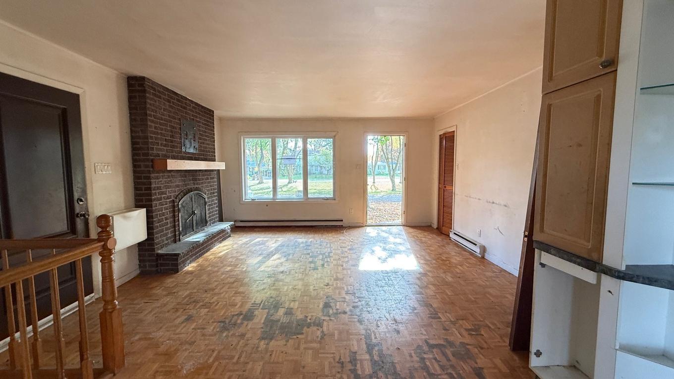 Living room - 35 Place Vadenais, Saint-Charles-Borromée, QC - Indoor Photo Showing Other Room With Fireplace