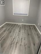 Empty room featuring wood finished floors and baseboards -