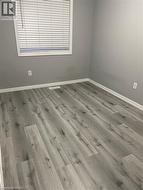 Empty room with wood finished floors and baseboards -