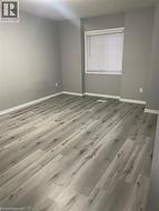 Empty room featuring baseboards and wood finished floors -