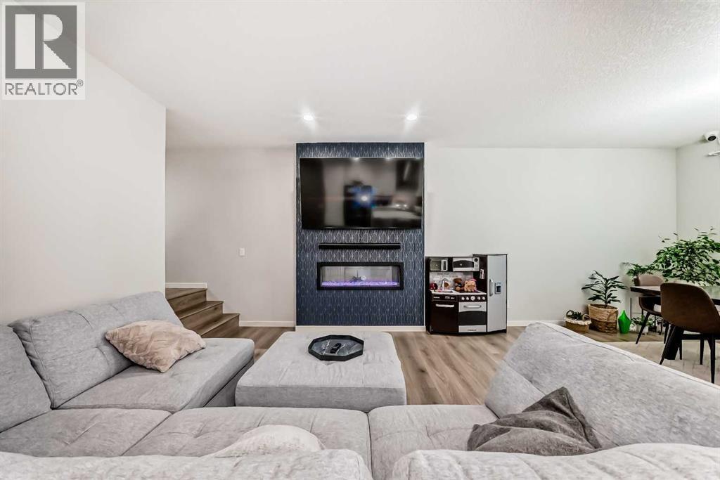 54 Seton Manor Se, Calgary, AB - Indoor Photo Showing Living Room With Fireplace