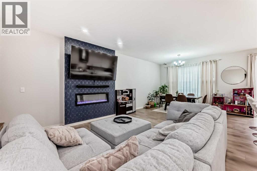 54 Seton Manor Se, Calgary, AB - Indoor Photo Showing Living Room With Fireplace