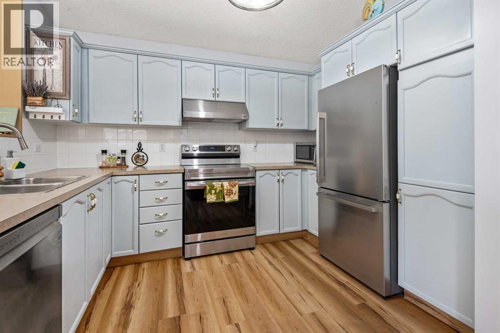 118 Bridleridge Way Sw, Calgary, AB - Indoor Photo Showing Kitchen With Double Sink