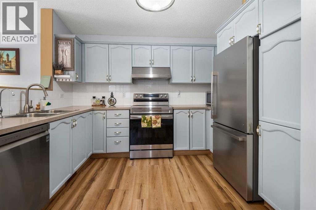 118 Bridleridge Way Sw, Calgary, AB - Indoor Photo Showing Kitchen With Double Sink