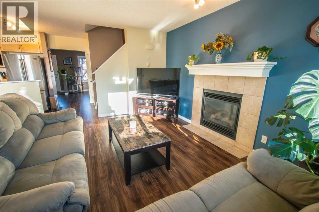 11 Saddlebrook Mews Ne, Calgary, AB - Indoor Photo Showing Living Room With Fireplace