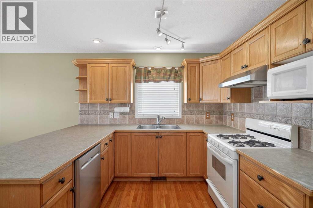25 Westfall Drive, Okotoks, AB - Indoor Photo Showing Kitchen With Double Sink