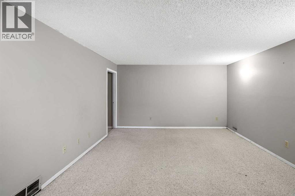 Fully finished basement with a rec room, 4th bedroom, 4pc bathroom, flex room (previously set up as a hair studio) and laundry room with storage - 467 Berkley Crescent Nw, Calgary, AB - Indoor Photo Showing Other Room
