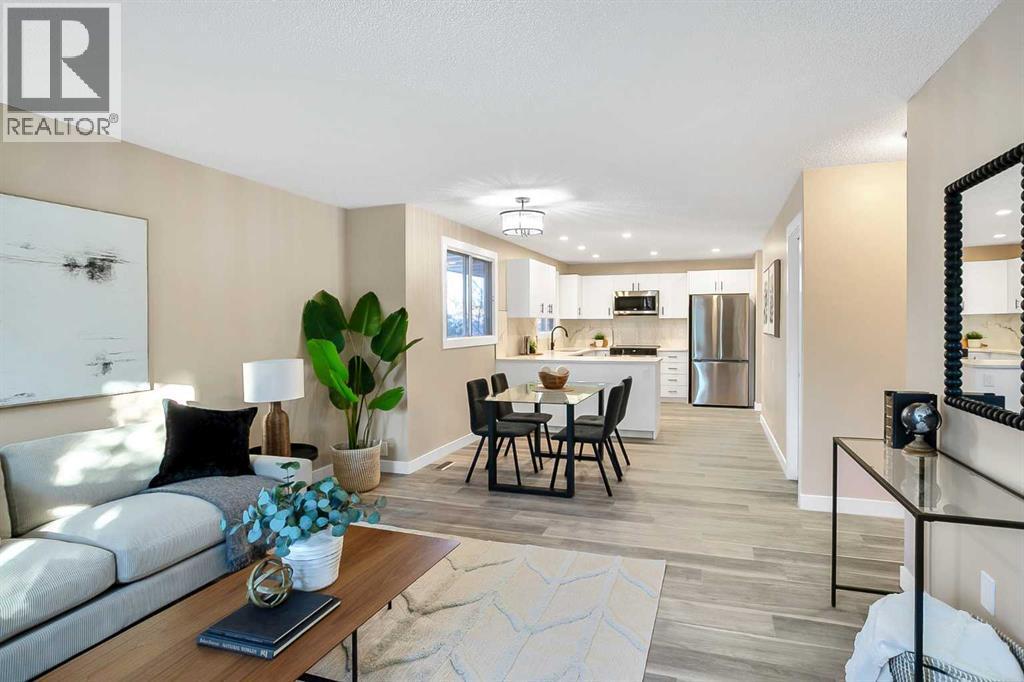 Open concept main floor with LVP - 467 Berkley Crescent Nw, Calgary, AB - Indoor Photo Showing Living Room