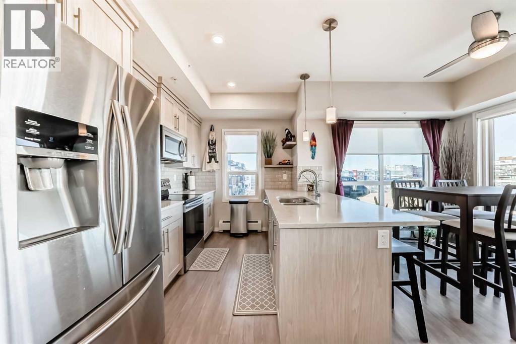 409, 4150 Seton Drive Se, Calgary, AB - Indoor Photo Showing Kitchen With Double Sink With Upgraded Kitchen