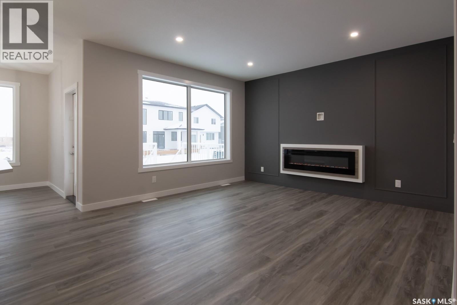 203 Sharma Lane, Saskatoon, SK - Indoor Photo Showing Living Room With Fireplace