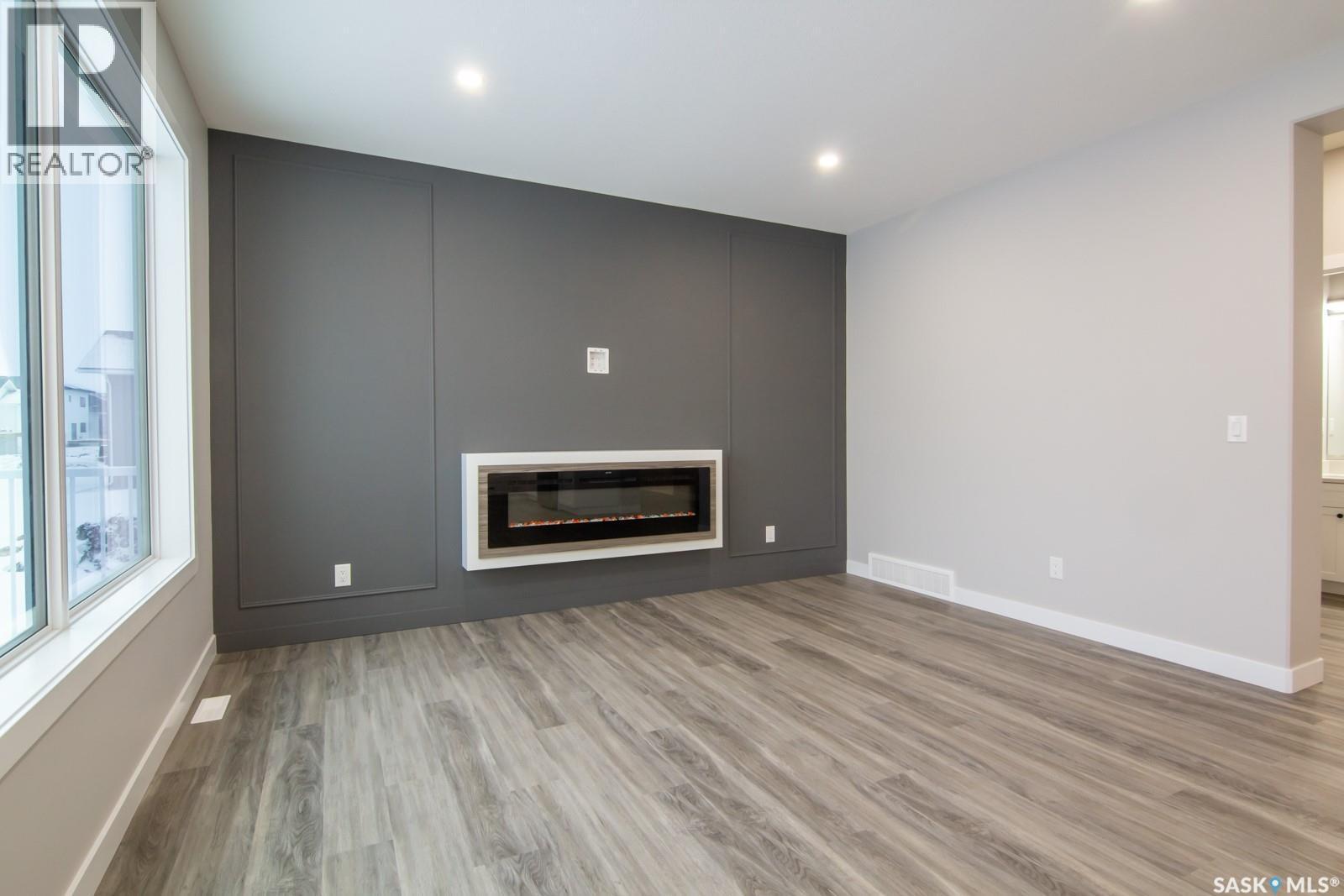 203 Sharma Lane, Saskatoon, SK - Indoor Photo Showing Living Room With Fireplace