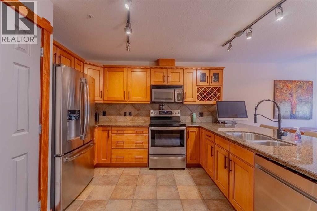 313, 170 Crossbow Place, Canmore, AB - Indoor Photo Showing Kitchen With Double Sink