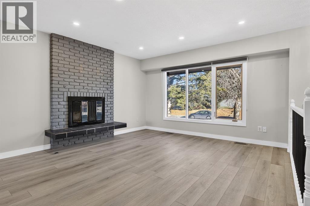 255 Rundleridge Drive Ne, Calgary, AB - Indoor Photo Showing Living Room With Fireplace