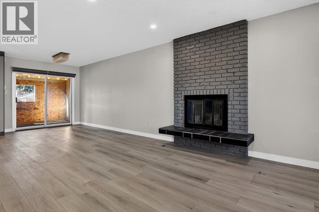 255 Rundleridge Drive Ne, Calgary, AB - Indoor Photo Showing Living Room With Fireplace